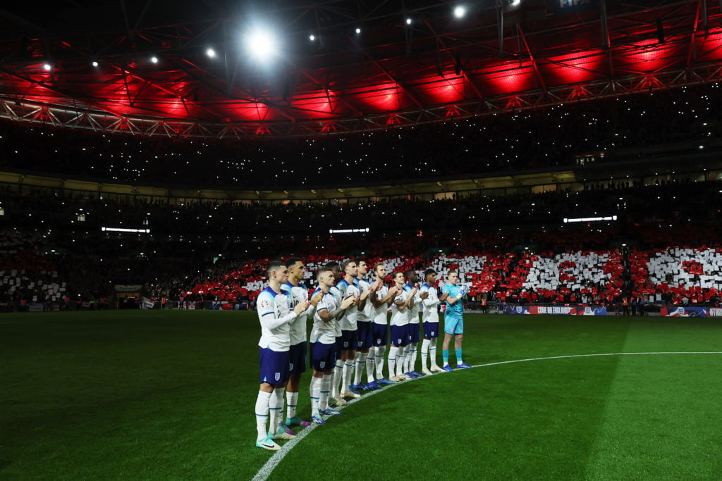 In this handout image provided by The FA, players of England take part in a minutes applause in remembrance of Sir Bobby Charlton CBE prior to the ...