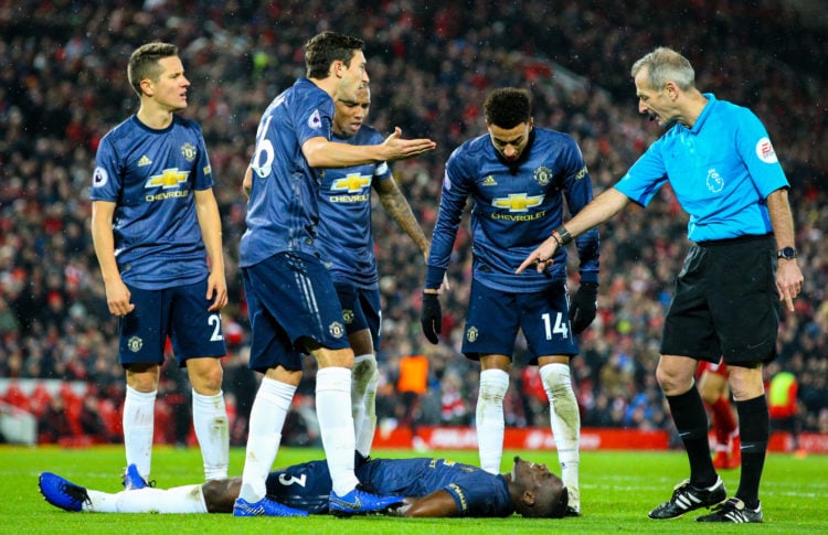 Manchester United's Eric Bailly lays injured during the Premier League match between Liverpool FC and Manchester United at Anfield on December 16, ...