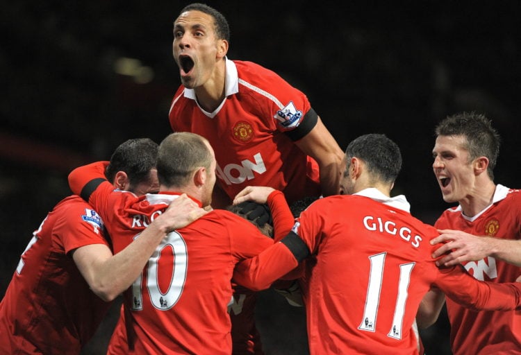 Manchester United's English defender Rio Ferdinand (up) celebrates with Manchester United's Serbian defender Nemanja Vidic (Hidden) after Vidic sco...