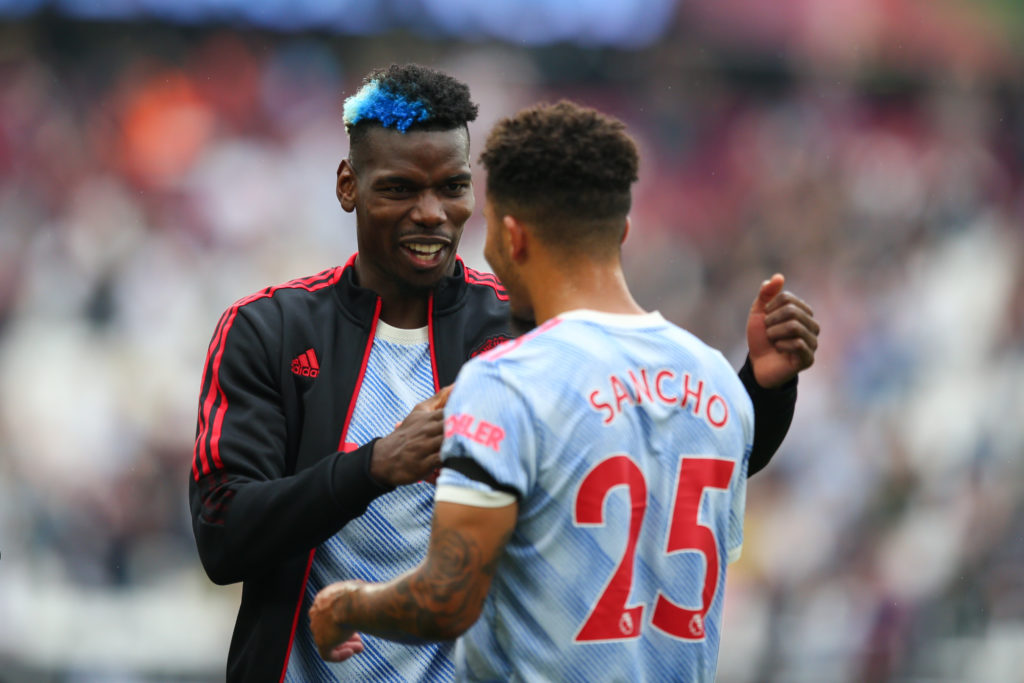 Paul Pogba celebrates with Jadon Sancho after a win with Man Utd