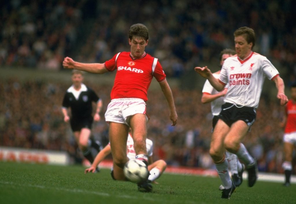 Norman Whiteside taking on Steve Nicholl of Liverpool