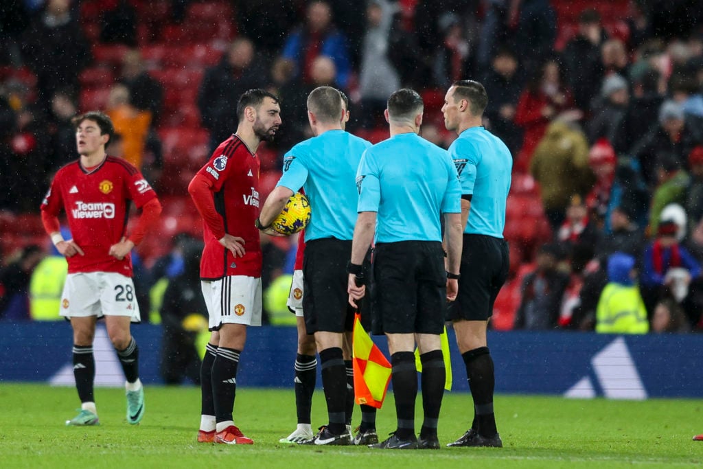 Bruno Fernandes of Manchester United with match officials after his sides 3-0 defeat during the Premier League match between Manchester United and ...