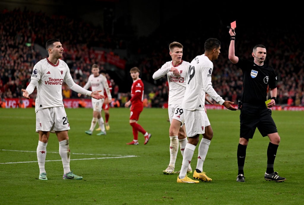 Michael Oliver shows Diogo Dalot a red card