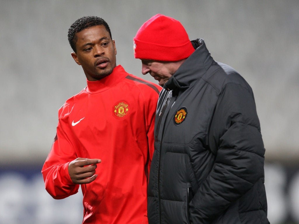 Patrice Evra (L) and Sir Alex Ferguson of Manchester United in action during a first team training session ahead of their UEFA Champions League mat...