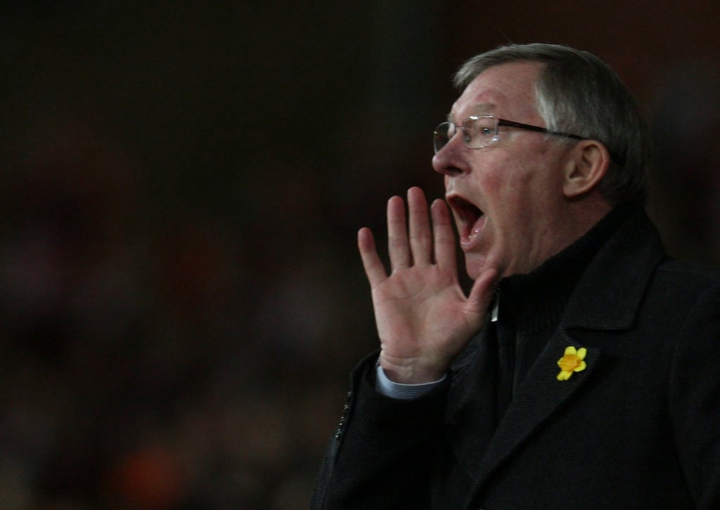 Manager Sir Alex Ferguson of Manchester United shouts instructions from the dugout during the UEFA Europa League Round of 16 first leg match betwee...