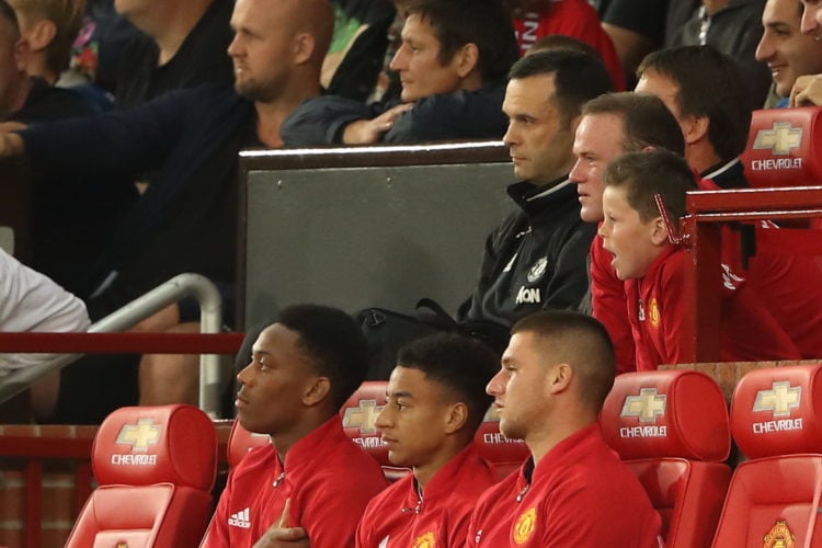 Wayne Rooney of Manchester United watches the game with his son Kai during the Wayne Rooney Testimonial match between Manchester United and Everton...