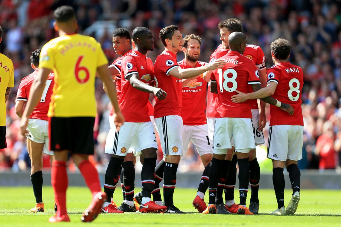 Michael Carrick of Man Utd (C) is congratulated by his teammates after setting up their winning goal during the Premier League match between Manche...