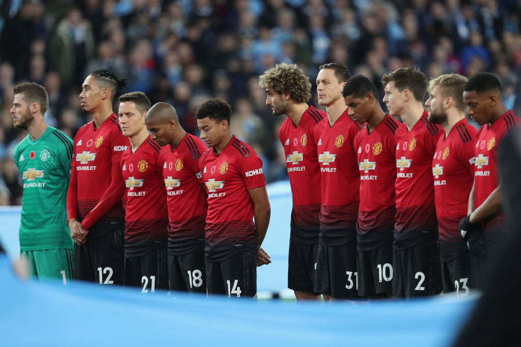 The Manchester United team take part in a minute's silence to mark Remembrance Sunday ahead of the Premier League match between Manchester City and...