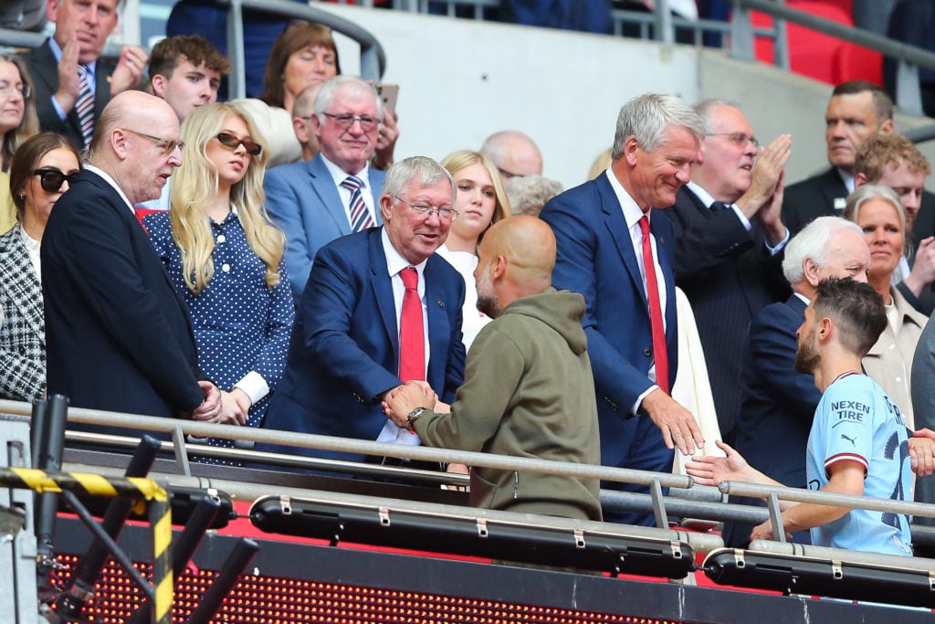 Josep 'Pep' Guardiola, manager of Manchester City,  is greeted by Sir Alex Ferguson, former manager of Manchester United, after the FA Cup final ma...