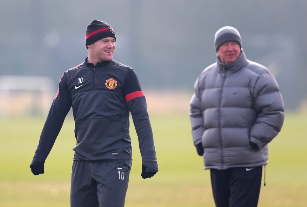 Wayne Rooney of Manchester United and Sir Alex Ferguson look on during a training session at Carrington Training Ground on March 4, 2013 in Manches...