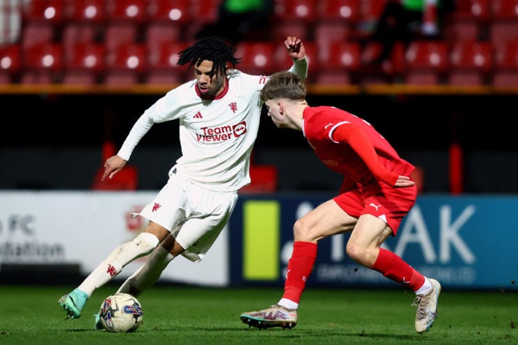 Ethan Williams of Manchester United runs at Joel McGregor of Swindon the FA Youth Cup match between Swindon Town and Manchester United at County Gr...