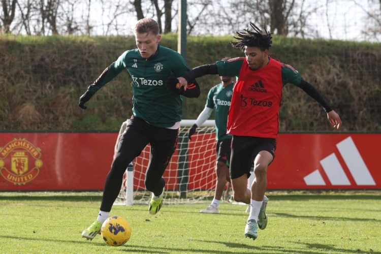 Scott McTominay of Manchester United competes with Ethan Williams during a Manchester United first team training session at Carrington Training Gro...