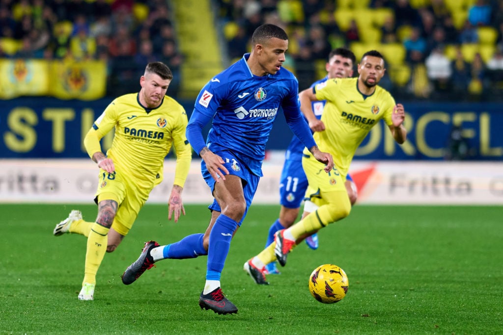 Mason Greenwood of Getafe CF runs with the ball whilst under pressure from Alberto Moreno of Villarreal CF during the LaLiga EA Sports match betwee...