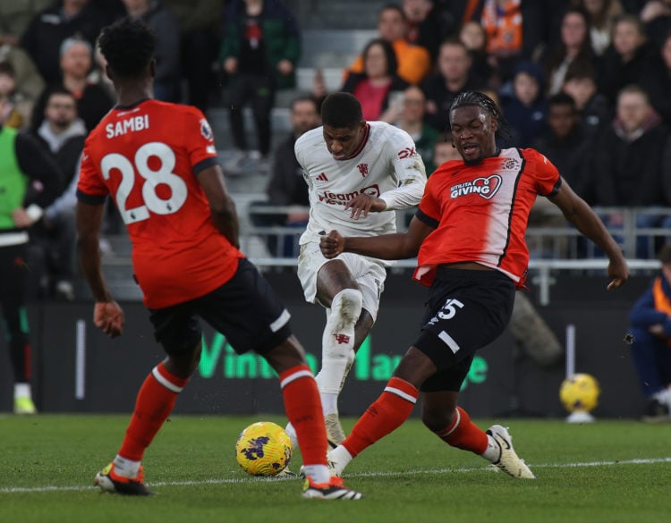 Marcus Rashford of Manchester United in action with Teden Mengi of Luton Town during the Premier League match between Luton Town and Manchester Uni...