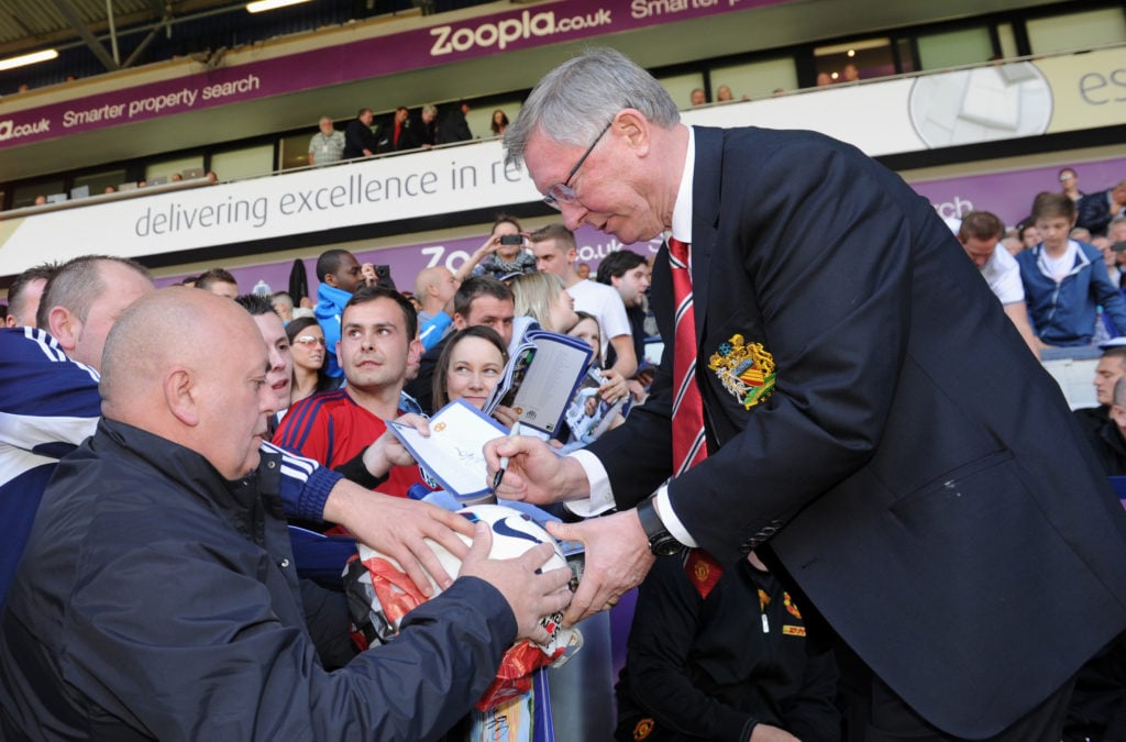 Sir Alex Ferguson the head coach / manager of Manchester United signs autographs before his 1500th an final match, at The Hawthorns the home stadiu...