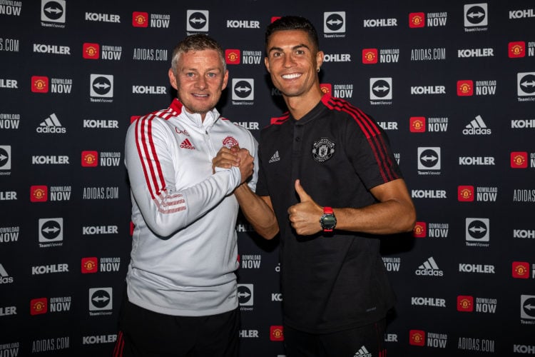 (EXCLUSIVE COVERAGE) Cristiano Ronaldo of Manchester United poses with Manager Ole Gunnar Solskjaer after signing his contract with the club at Car...