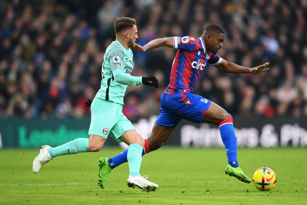 Cheick Doucoure of Crystal Palace runs ahead of Alexis Mac Allister of Brighton & Hove Albion during the Premier League match between Crystal P...