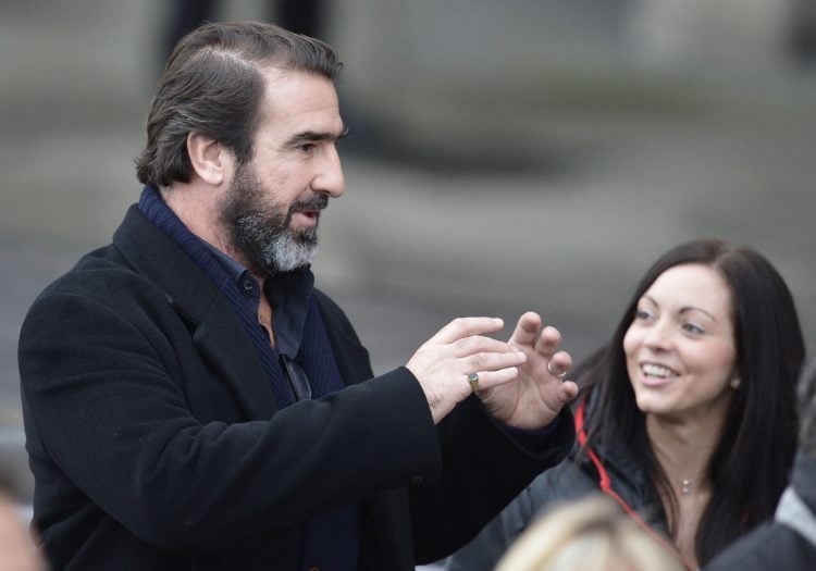 Former Manchester United player Eric Cantona (L) reacts during the unveiling of a statue of Manchester United's manager Alex Ferguson at Old Traffo...