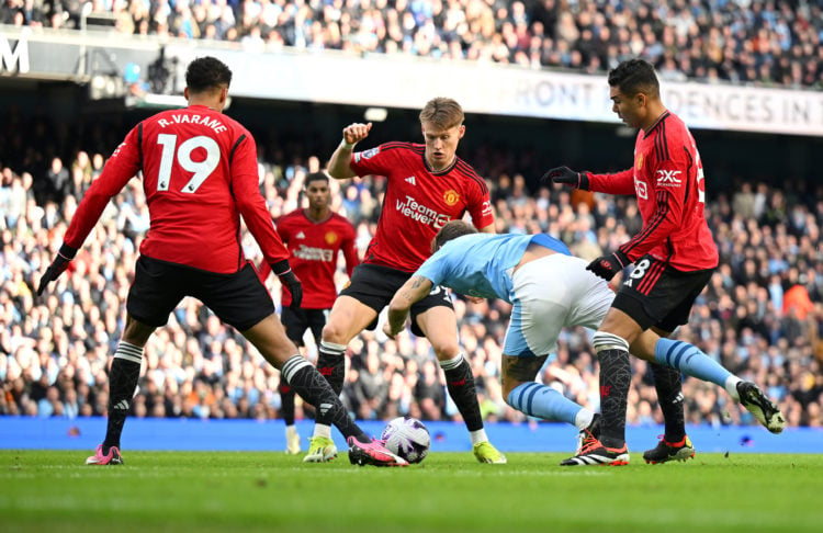 John Stones of Manchester City is challenged in the box by Casemiro of Manchester United during the Premier League match between Manchester City an...