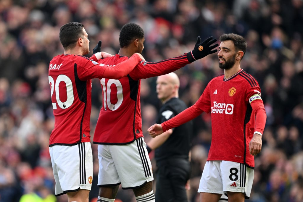 Marcus Rashford of Manchester United celebrates scoring his team's second goal from the penalty spot with teammates Diogo Dalot and Bruno Fernandes...