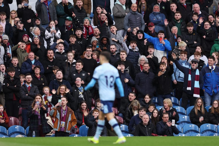 Burnley fans gesture towards Sergio Reguilon of Brentford after he received a red card during the Premier League match between Burnley FC and Brent...