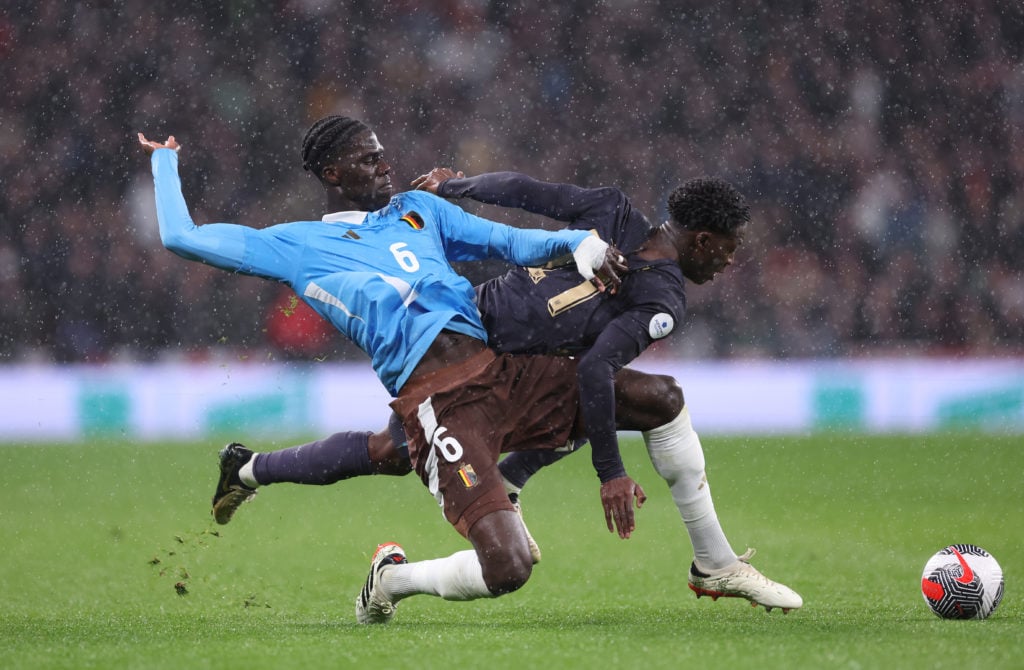 Kobbie Mainoo of England is tackled by Amadou Onana of Belgium during the international friendly match between England and Belgium at Wembley Stadi...