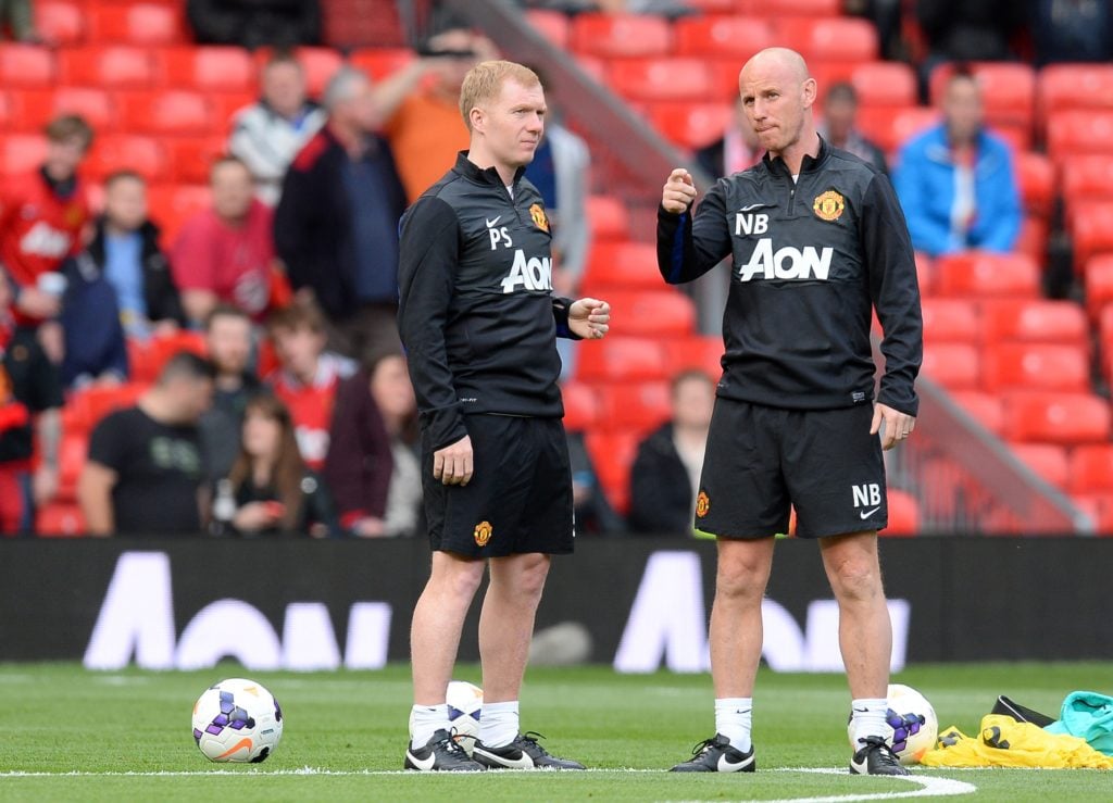 Manchester United coaching staff Paul Scholes (L) and Nicky Butt are pictured before the start of the English Premier League football match between...