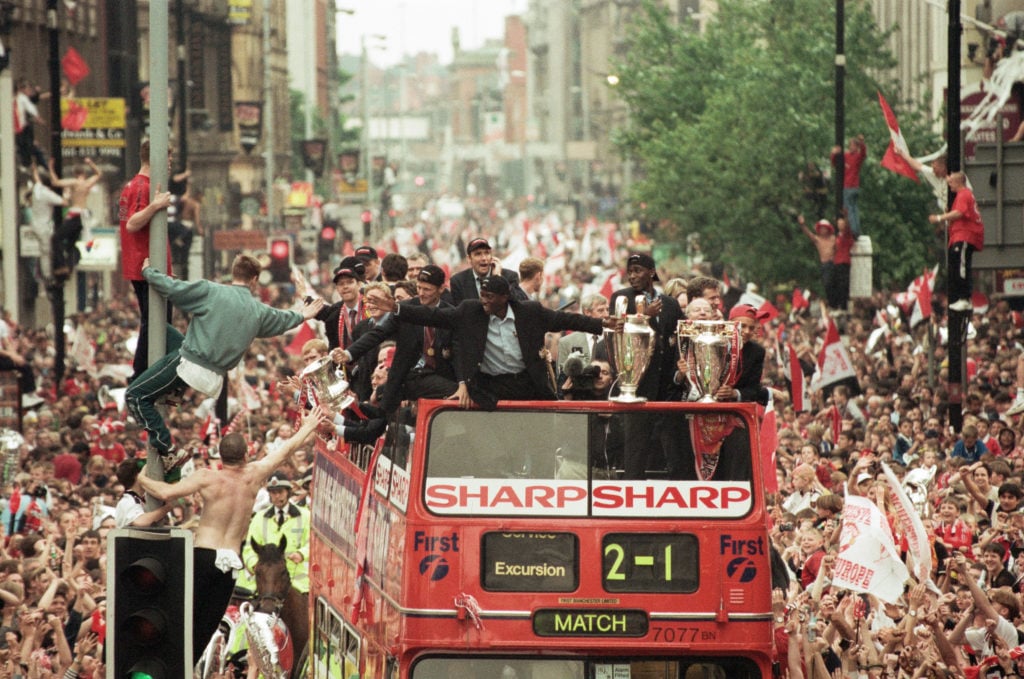 Manchester United celebrate winning the treble as the jubilant team make their way through Manchester during an open top bus parade. Teddy Sheringh...
