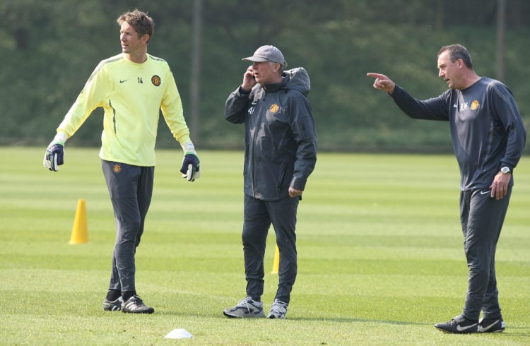 Sir Alex Ferguson of Manchester United speaks on the phone during a first team training session at Carrington Training Ground on April 29, 2011 in ...