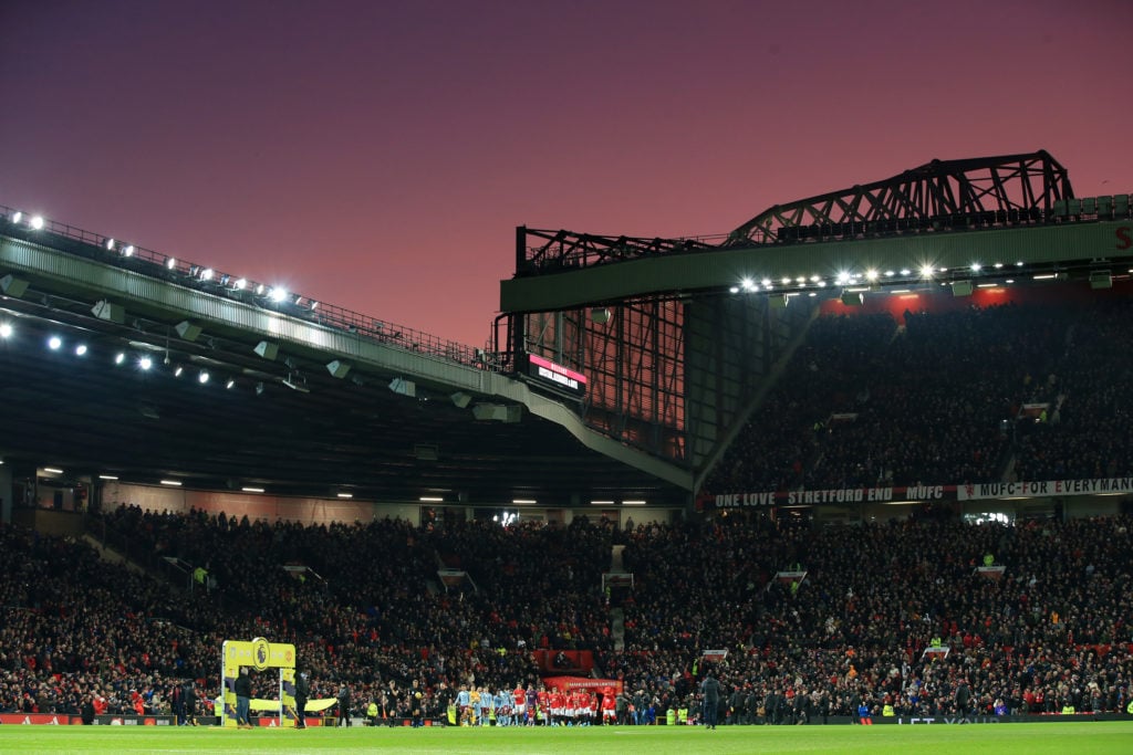A general view as the two teams walk out under a sunset for the Premier League match between Manchester United and Aston Villa at Old Trafford on D...
