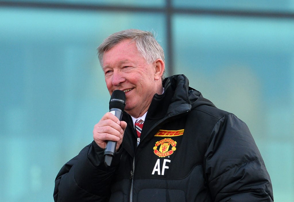 Retiring iconic Manchester United manager Alex Ferguson addresses the crowds from the champions' bus outside Old Trafford Stadium in Manchester, no...