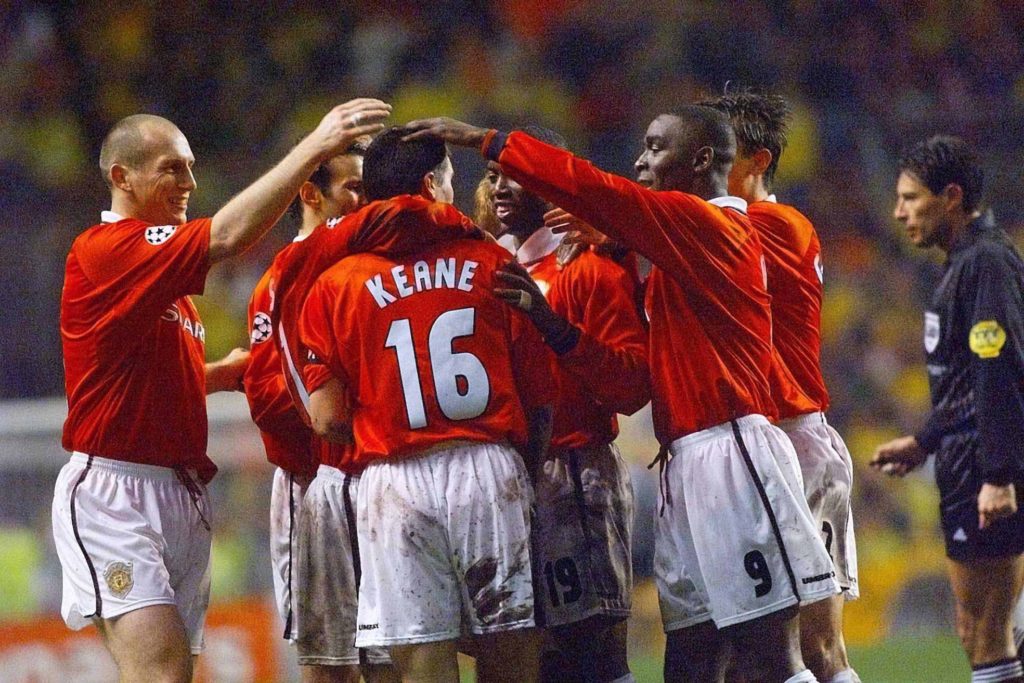 Manchester United's record-signing Dutch back Jaap Stam (L), Andy Cole (R), Twight Yorke (C) of Trinidad-Tobago and other teammates congratulate Ro...