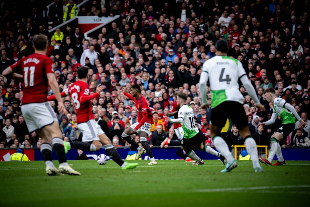 Marcus Rashford of Manchester United in action with Alexis Mac Allister of Liverpool FC during the Premier League match between Manchester United a...