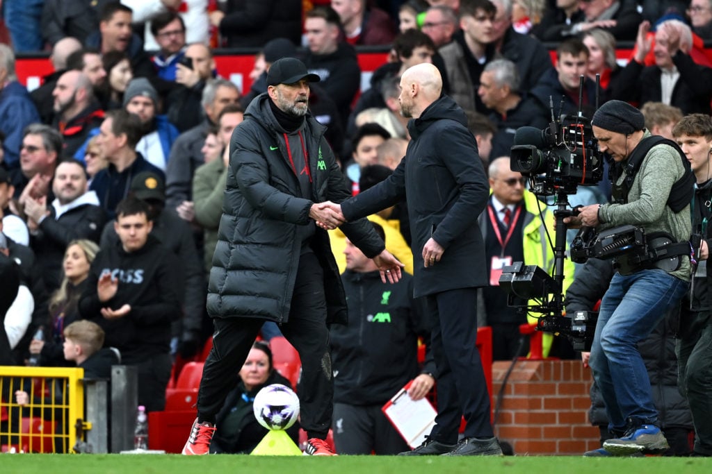 Jurgen Klopp, Manager of Liverpool, and Erik ten Hag, Manager of Manchester United, interact at the full-time whistle during the Premier League mat...