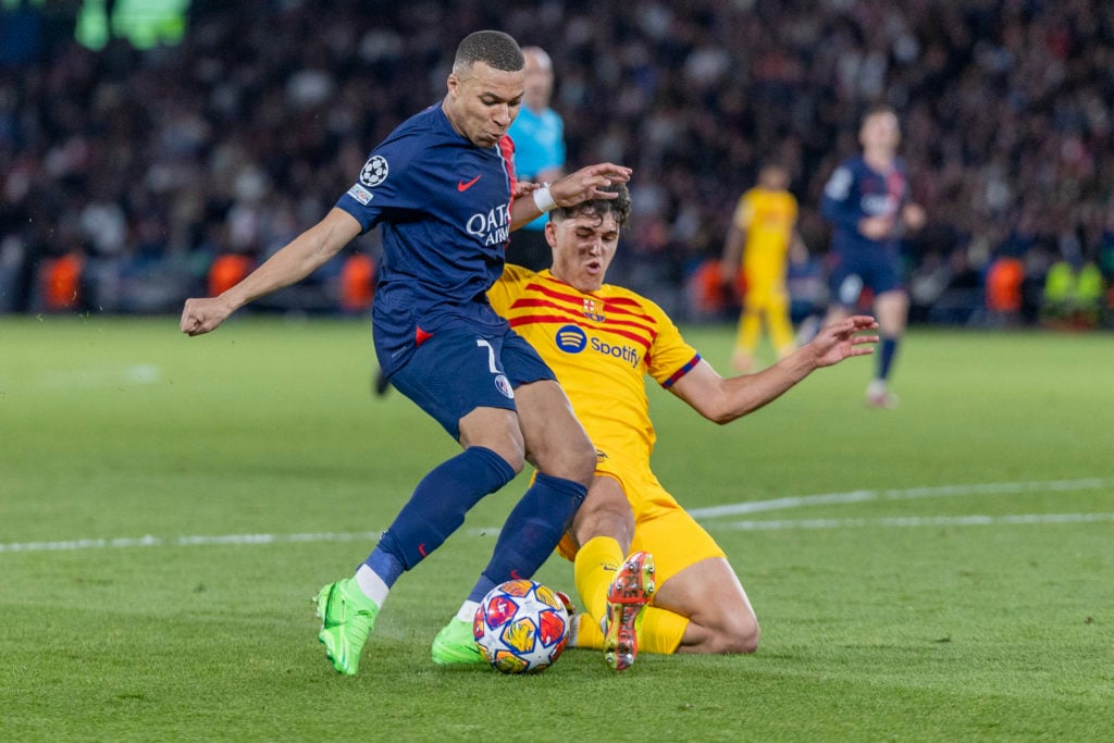 Kylian Mbappé #7 of Paris Saint-Germain defended by Pau Cubarsí #33 of Barcelona during the Paris Saint-Germain V Barcelona, UEFA Champions League,...