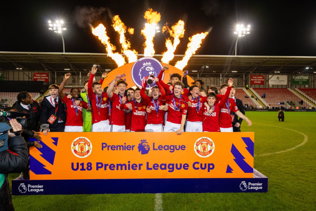 Finley McAllister of Manchester United lifts the trophy with his team-mates following their victory during the U18 Premier League Cup Final match b...