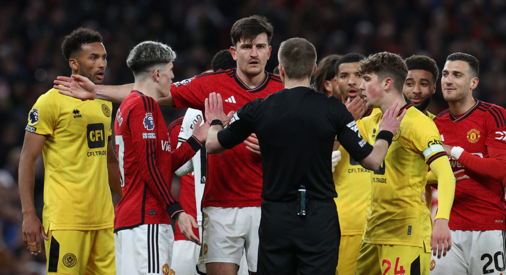 Harry Maguiret of Manchester United talks to referee Michael Salisbury during the Premier League match between Manchester United and Sheffield Unit...