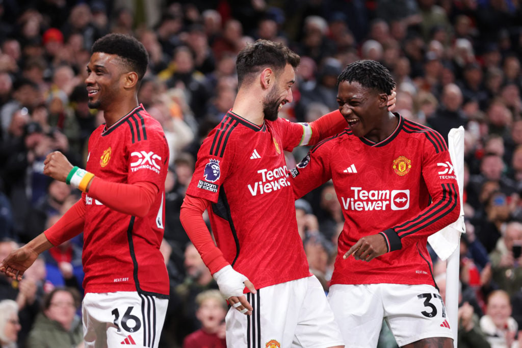 Bruno Fernandes of Manchester United celebrates scoring his team's third goal with Kobbie Mainoo during the Premier League match between Manchester...