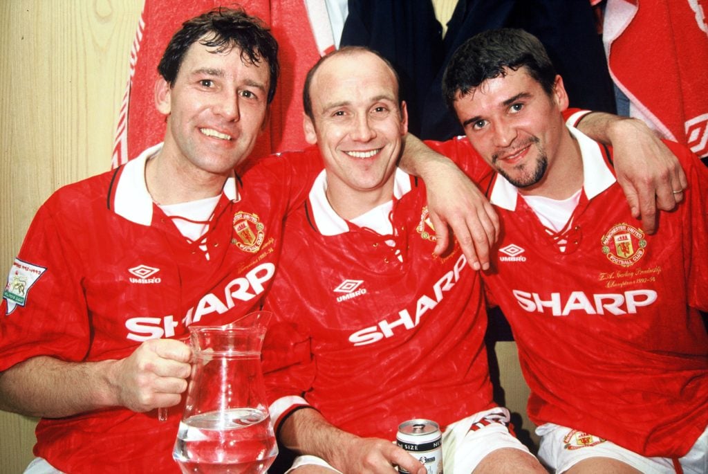 Bryan Robson, Mike Phelan and Roy Keane of Manchester United celebrates in the dressing room with the Premiership Trophy after becoming FA Carling ...