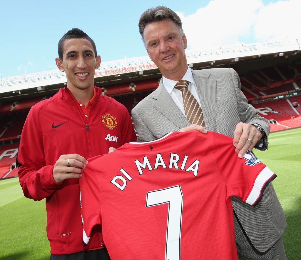 Angel di Maria of Manchester United poses with manager Louis van Gaal and his new shirt number ahead of a press conference to unveil him at Old Tra...