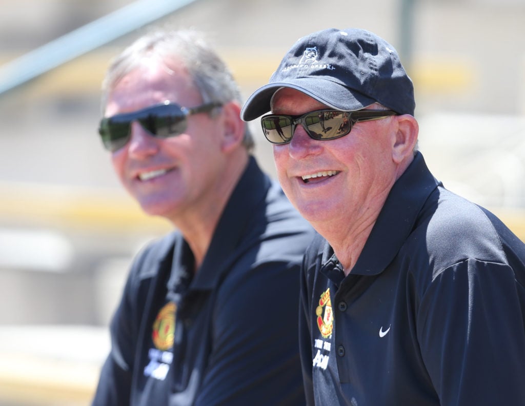 (EXCLUSIVE COVERAGE) Former captain Bryan Robson and former manager Sir Alex Ferguson of Manchester United watch during a first team training sessi...