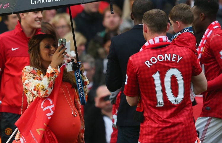 Wayne Rooney of Manchester United has his picture taken by his wife Coleen following the Barclays Premier League match between Manchester United an...