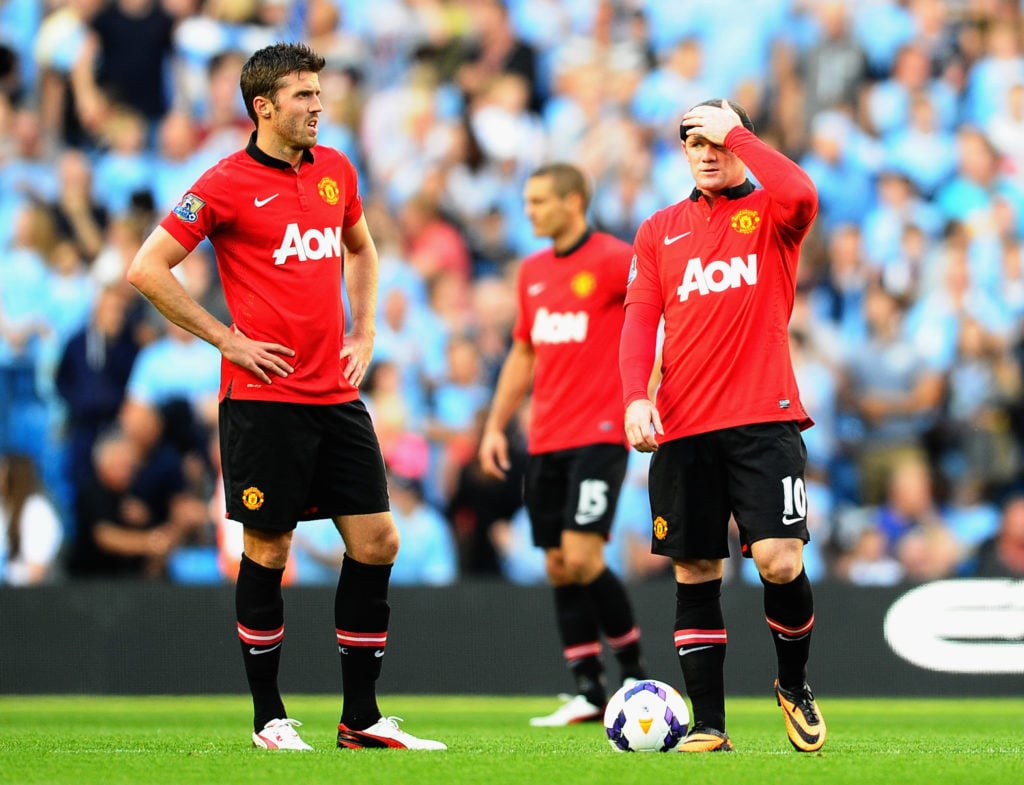 Wayne Rooney (R) and Michael Carrick of Manchester United look dejected during the Barclays Premier League match between Manchester City and Manche...