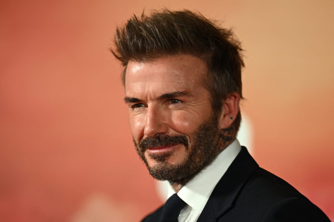 Former Manchester United footballer David Beckham poses on the red carpet upon arrival to attend the world premiere of the documentary '99', in Man...