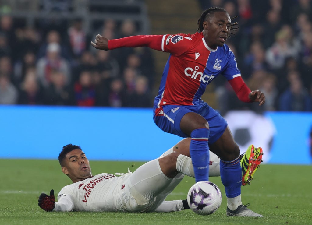 Casemiro of Manchester United in action with Eberechi Eze of Crystal Palace during the Premier League match between Crystal Palace and Manchester U...