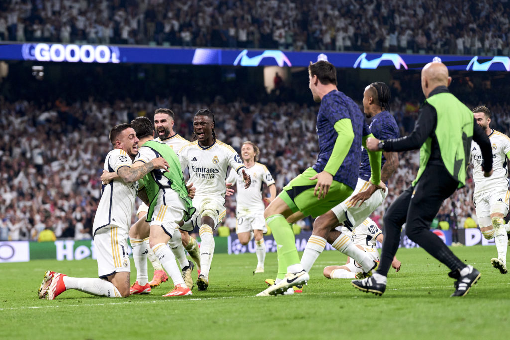 Real Madrid's Joselu Mato celebrates after scoring his team's second goal with his teammates during the UEFA Champions League semi-final match...