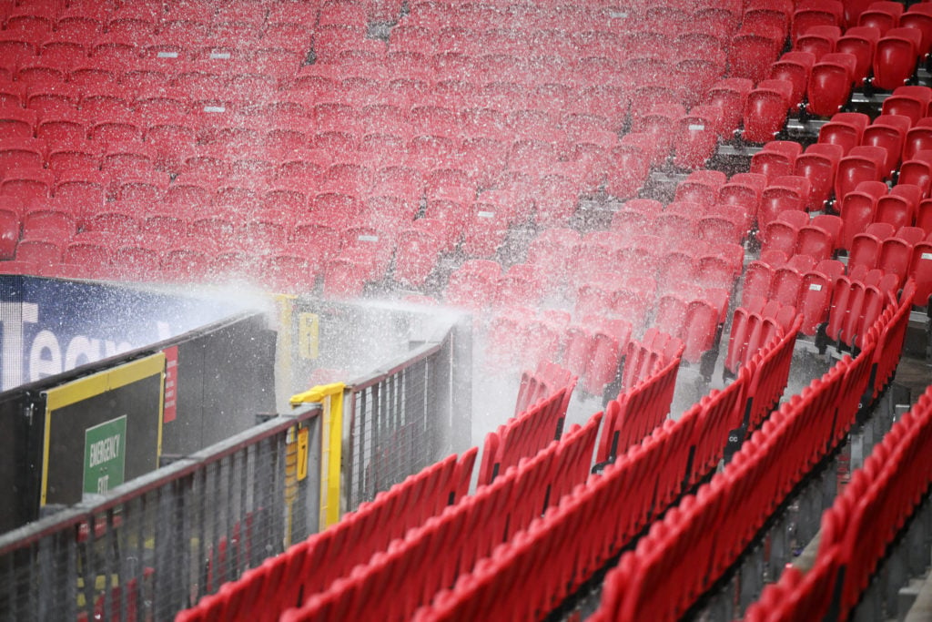 A general view as the drainage pipe in the roofs of the Sir Alex Ferguson Stand and East Stand leaks and pours onto the seats below following heavy...