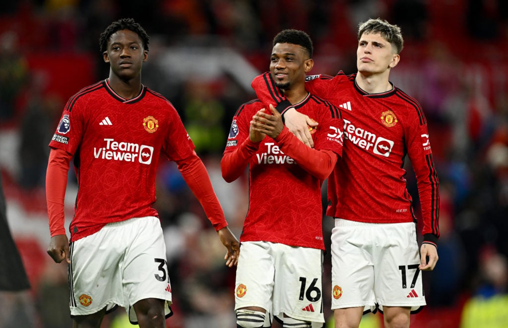 Kobbie Mainoo, Amad Diallo and Alejandro Garnacho of Manchester United applaud the fans after the team's victory during the Premier League match be...