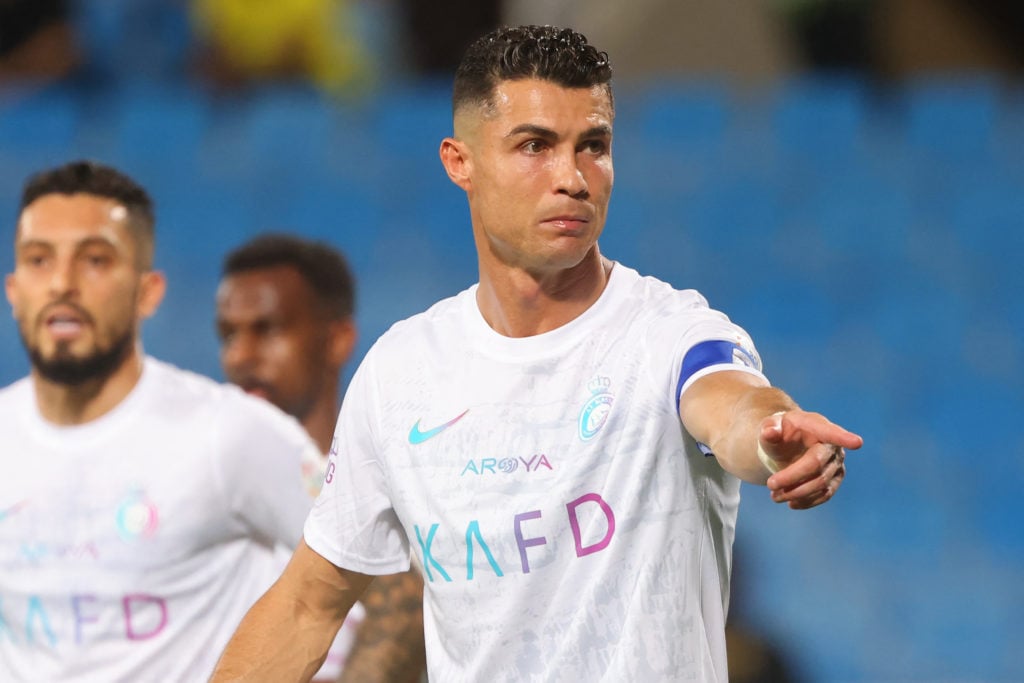 Nassr's Portuguese forward #07 Cristiano Ronaldo speaks with teammates during the Saudi Pro League football match between Al-Riyadh and Al-Nassr at...