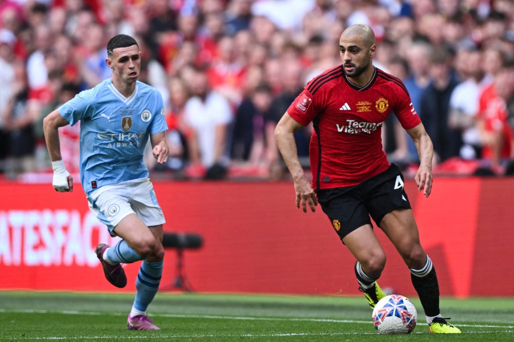 Manchester City's English midfielder #47 Phil Foden (L) runs after Manchester United's Moroccan midfielder #04 Sofyan Amrabat (R) during the Englis...